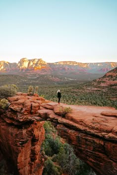 a person standing on the edge of a cliff