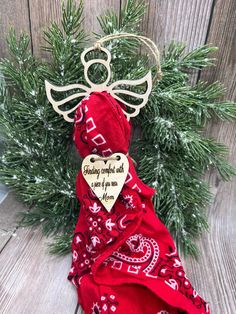 a red scarf with an angel decoration hanging from it