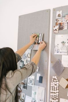 a woman is working on a bulletin board