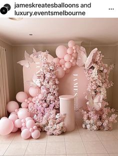 a room with balloons and flowers on the wall