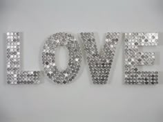 the word love is made up of silver sequins