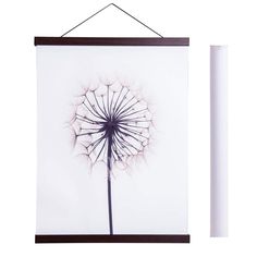 a dandelion hanging on a wall next to a white stick