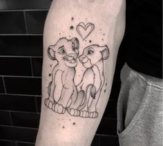 a couple of lions tattoo on the left forearm and arm, with hearts in the background