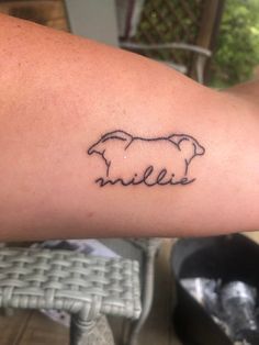 a person with a tattoo on their arm that has a sheep in the middle of it