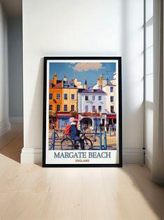 there is a poster on the floor in front of a window that says margate beach