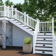 a deck with chairs and table next to a white stair case on the side of a house