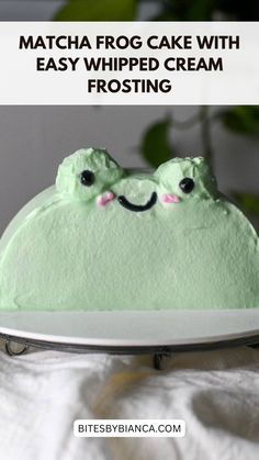 a cake with green frosting and two eyes on it that says matcha frog cake with easy whipped cream frosting