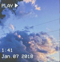 the sky is blue with clouds and power lines in front of it that says play