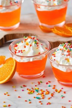 These easy vodka jello shots are made with orange jello and vodka, then topped with whipped cream and sprinkles. Great for orange Halloween jello shots and orange theme parties.