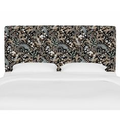 an upholstered headboard with flowers and leaves