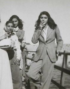 black and white photograph of four people on a pier