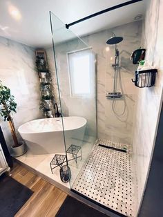 a white bath tub sitting inside of a bathroom next to a sink and shower head