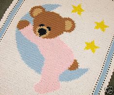 a baby blanket with a teddy bear on it's side and stars around the edges