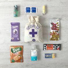 an assortment of snacks and candy laid out on a white wooden surface with the contents labeled