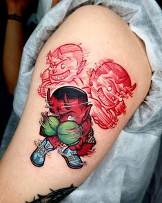 a man with a red and green tattoo on his arm