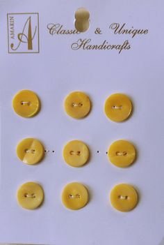 six yellow buttons are shown on a white card