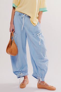 So slouchy and cool, these statement-making parachute pants will turn heads with every wear. **Fit:** Low-slung, exaggerated balloon fit **Features:** Pull-on design, drawstring detail at the waist, banded hemlines, oversized pouch pockets, striped fabrication **Why We ❤ It:** Sporty with sneakers or unexpected with ballet flats, this pair has endless ways to wear. | Outta Sight Parachute Pants by Free People in Blue, Size: S Top Over Shirt, Free People Spring, Free People Summer, Spring Inspo, Drawstring Detail, Kimono Duster, Beach Dresses, Fashion Tops, Playsuit Jumpsuit