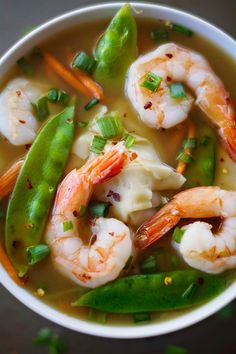 a white bowl filled with shrimp and veggies