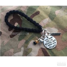 a couple of necklaces that are on top of a camo cloth surface with the words, this army is my soldier but he needs me