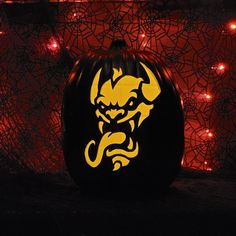 a pumpkin with an image of a demon on it