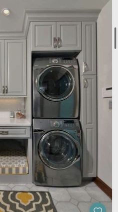 a washer and dryer sitting in a kitchen next to each other on the floor