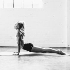 a woman is doing yoga on the floor