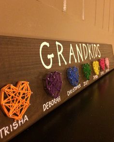 a sign that says grandkids on it with different colored hearts in the middle