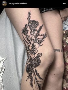 a woman's legs with flowers on them