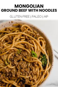 a white bowl filled with ground beef and noodles on top of a marble countertop