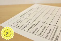 a close up of a piece of paper on top of a wooden table with a yellow seal