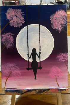 a painting of a woman sitting on a swing in front of the moon and trees