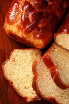 sliced loafs of bread sitting on top of a wooden table