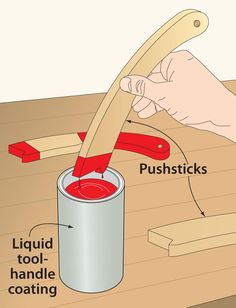 a person is using a brush to paint a wooden table with a red bucket and spatula