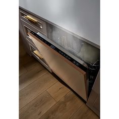 an empty dishwasher in the middle of a kitchen with wooden floors and white walls