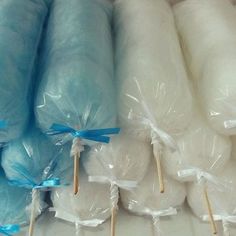 several rolls of white and blue cotton on sticks