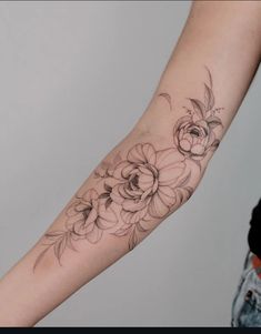 a woman's arm with flowers on it