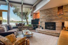 a living room filled with furniture and a flat screen tv on top of a fireplace