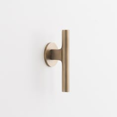 a close up of a door handle on a white wall