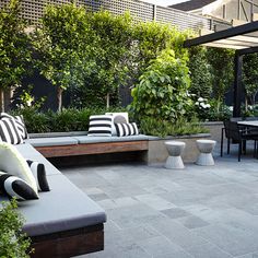 an outdoor seating area with black and white pillows