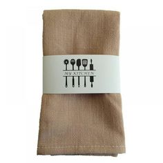 a set of three napkins with utensils on top of each one in brown linen