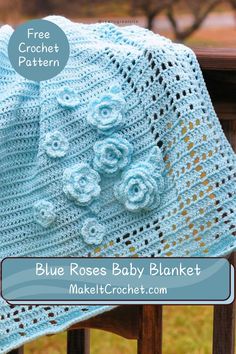 a crocheted blue rose baby blanket sitting on top of a wooden chair