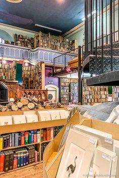 the inside of a bookstore with many books on shelves and pictures in front of them