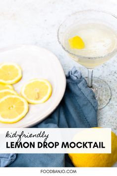 a lemon drop mock cocktail on a white plate next to sliced lemons and a blue towel