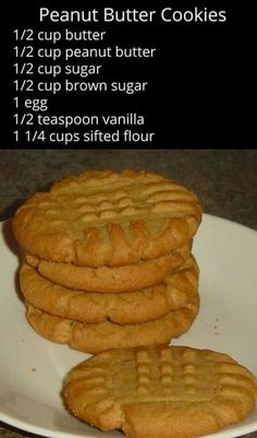 three peanut butter cookies stacked on top of each other in front of a white plate