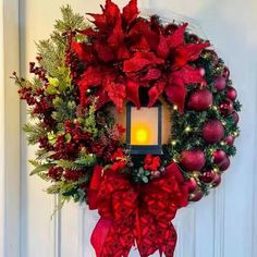 a christmas wreath with a lit candle on it