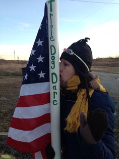 a woman is holding an american flag and blowing out the word deare on it