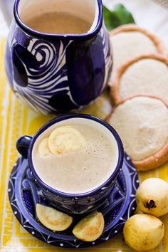 a cup of coffee and some cookies on a table