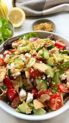 a salad with cucumber, tomatoes, lettuce and feta cheese