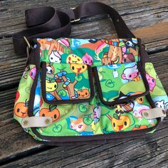 Tokidoki Le Sportsac Foresta Green Purse X Body Stellina Messenger Bag Kawaii Cartoon Rare Nylon Bag. 2 Exterior Flap Pockets. 1 Exterior Zipper Pocket. Rainbow Zipper Closure. 1 Inside Zipper Pocket. Adjustable Strap. Orange Lining. Measurements Are Approximate: Height - 9” (Not Including Strap) Width - 10” Depth - 5” No Stains, Rips, Tears, Or Holes. See Pictures For Additional Details Of Condition. Smoke Free Home. Kawaii Ideas, Green Purse, Kawaii Cartoon, Nylon Bag, Flap Pocket, Diaper Bag, Zipper Pocket, Messenger Bag, Satchel