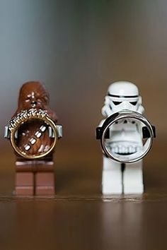 two star wars figurines, one with a ring and the other with a storm trooper